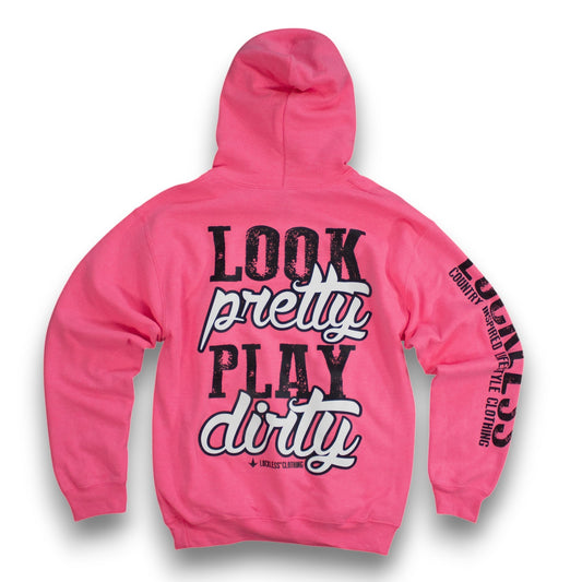 A bright pink hoodie shown from the back, featuring the text 'LOOK pretty PLAY dirty' in black and white across the center, with additional black text printed down the sleeves. The brand name 'Koolie Clothing' is visible in small print below the main graphic.